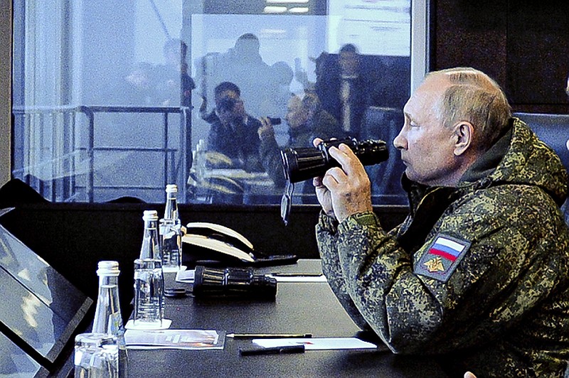 Russian President Vladimir Putin watches the Vostok 2022 (East 2022) military exercise in far eastern Russia, outside Vladivostok, on Tuesday, Sept. 6, 2022. The weeklong exercise that began Thursday is intended to showcase growing defense ties between Russia and China and also demonstrate that Moscow has enough troops and equipment to conduct the massive drills even as its troops are engaged in military action in Ukraine. (Mikhail Klimentyev, Sputnik, Kremlin Pool Photo via AP)