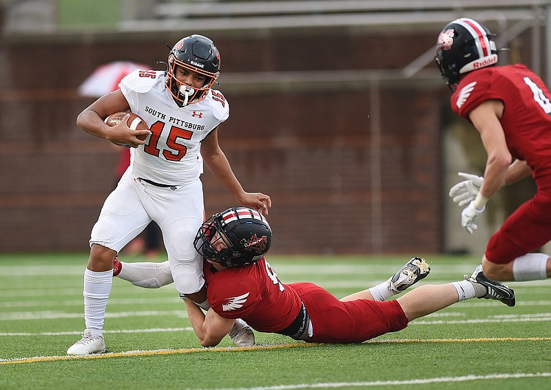 Staff photo by Matt Hamilton / South Pittsburgh (15) Kamden Wellington tries to elude Signal Mountain (9) Rip Hutcherson  at Finley Stadium on Thursday, August 11, 2022.