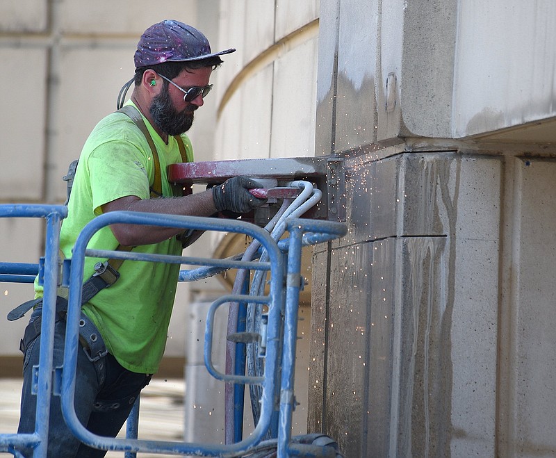 Staff file photo by Matt Hamilton / Alex Fischer works on the expansion at the Chattanooga Airport on Tuesday, June 21, 2022. The $28 million project will add new boarding gates, grow the security checkpoint and bolster amenities, according to the airport.