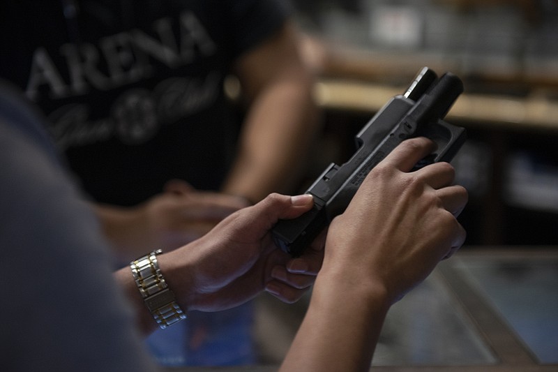 New York Times file photo / A pistol user handles a gun at a firing range in Laredo, Texas, in 2019.