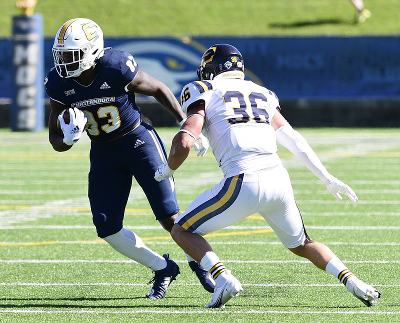 Staff Photo by Robin Rudd / Chattanooga’s Keyshawn Toney (83) looks for running room after a reception. Defending for East Tennessee is Zach West (36). The University of Tennessee at Chattanooga hosted the East Tennessee State University Buccaneers in a Southern Conference football game, at Finley Stadium, on October 17, 2021.