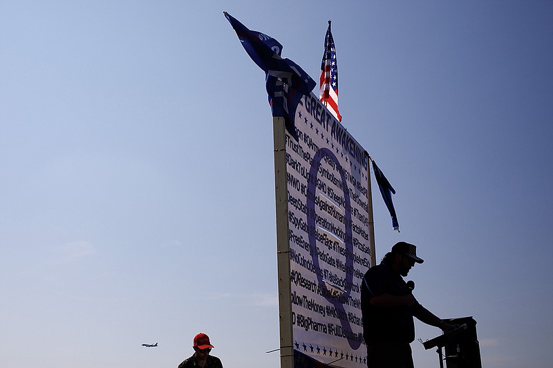 New York Times file photo / A speaker at a QAnon rally stands by the Washington Monument on Sept. 11, 2019.