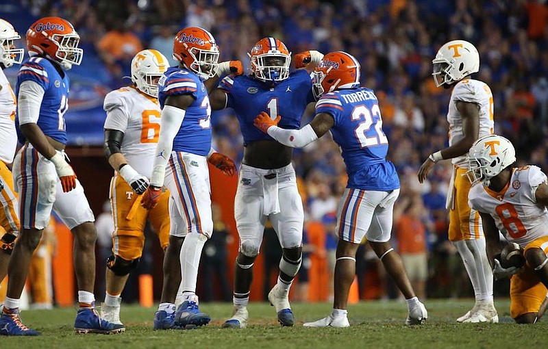 Florida Athletics photo / Florida outside linebacker Brenton Cox (1) and safety Rashad Torrence celebrate a stop during last season’s 38-14 win over Tennessee as Volunteers quarterback Hendon Hooker, second from right, looks on. The Gators travel to Knoxville this week having defeated the Vols 16 times in the past 17 years.