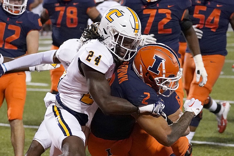 AP photo by Charles Rex Arbogast / Illinois running back Chase Brown (2) carries UTC defensive back Josh Battle into the end zone for a touchdown during the first half of Thursday night's game in Champaign, Ill. Illinois won 31-0 as the Mocs lost for the first time in four games to start the season.