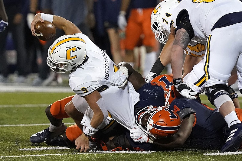 AP photo by Charles Rex Arbogast / UTC quarterback Preston Hutchinson is sacked by Seth Coleman, right, and Jer'Zhan Newton during Thursday night's game at Illinois.