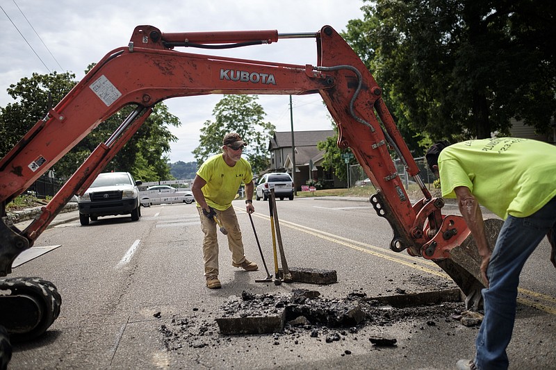 Staff photo / Kenneth Sutherland, left, and Tommy McLemore with Leslie Allen Green Plumbing Contractor work on reaching on a sewer line outside a home under construction at 1513 Bailey Avenue on Tuesday, June 28, 2016. The work temporarily closed westbound traffic on the street.