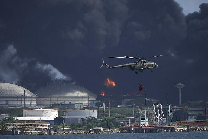Associated Press File Photo/Ramon Espinosa / Flames and smoke as are visible in a fire at the Matazanas Supertanker Base in Matazanas, Cuba, are what confronted local firefighters in a storage tank fire here 50 years ago Sunday.