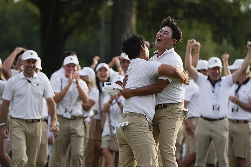 AP photo by Chris Carlson / Tom Kim, left, embraces fellow South Korean golfer and International teammate Si Woo Kim after they won their Presidents Cup fourball match on the 18th hole Saturday at Quail Hollow Club in Charlotte, N.C.