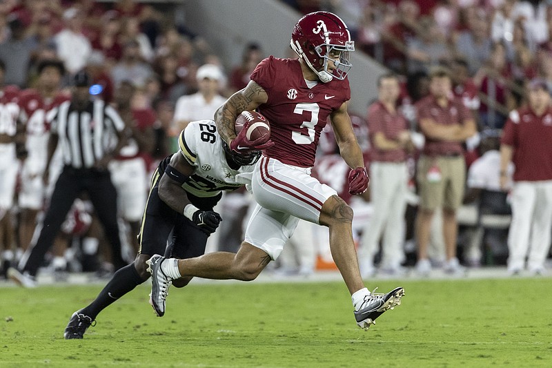 AP photo by Vasha Hunt / Alabama wide receiver Jermaine Burton runs away from Vanderbilt defensive back BJ Anderson during the first half of Saturday night's game in Tuscaloosa, Ala.