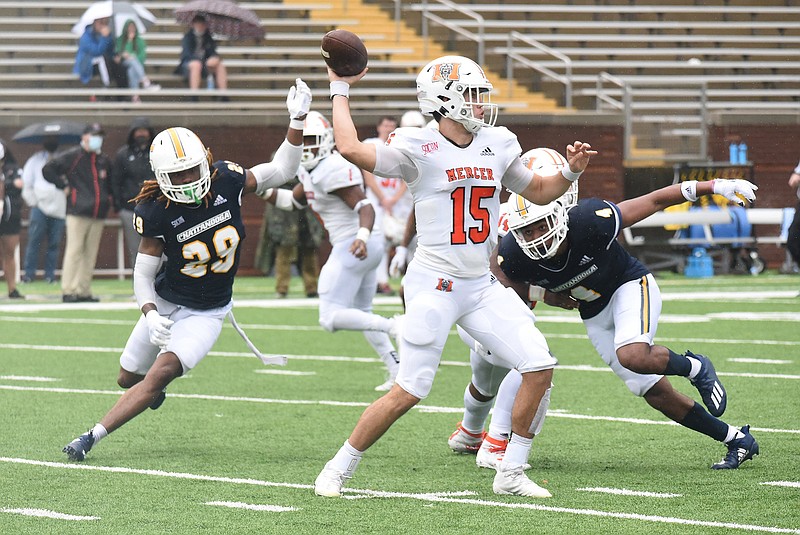 Staff photo by Matt Hamilton / UTC's Romeo Wykle, right, closes in on Mercer quarterback Carter Peevy during a SoCon game in March 2021 at Finley Stadium.