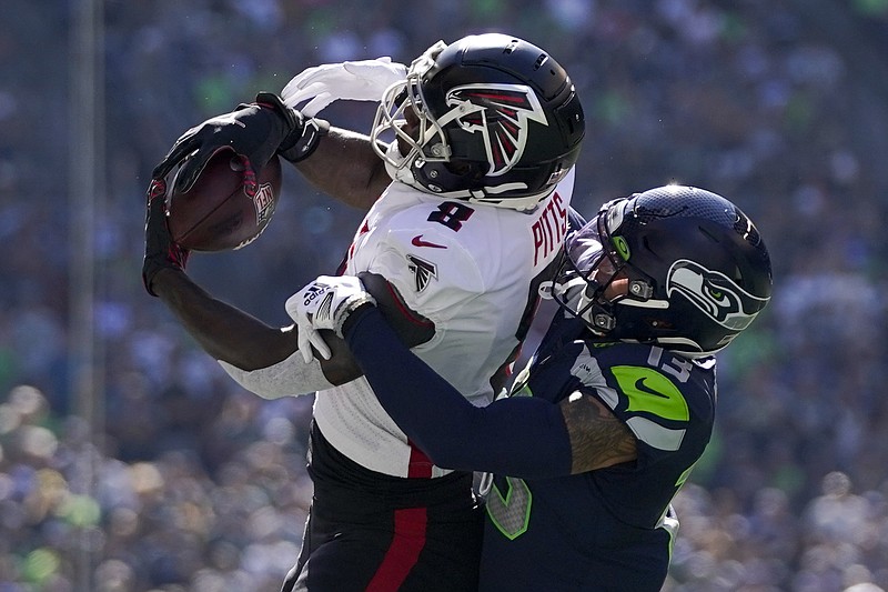 AP photo by Ashley Landis / Atlanta Falcons tight end Kyle Pitts hauls in a pass while covered by Seattle Seahawks safety Josh Jones during Sunday's game. Pitts finished with five catches for 87 yards to help the Falcons win 27-23 in Seattle and avoid what would have been their second 0-3 start in three seasons.
