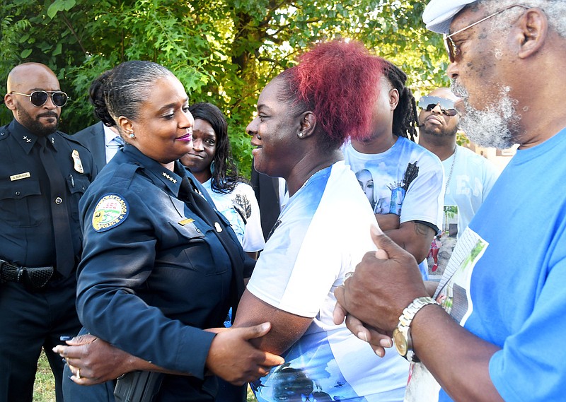 Staff Photo By Robin Rudd /  Chattanooga Police Chief Celeste Murphy, second from left, speaks with Evette Hughes, the mother of homicide victim Keniqua Hughes, as Keniqua's grandfather, Anthony Lofton, right, looks on when Murphy made an appeal in the Westside neighborhood in May for information on the 2021 case in which two women were killed.