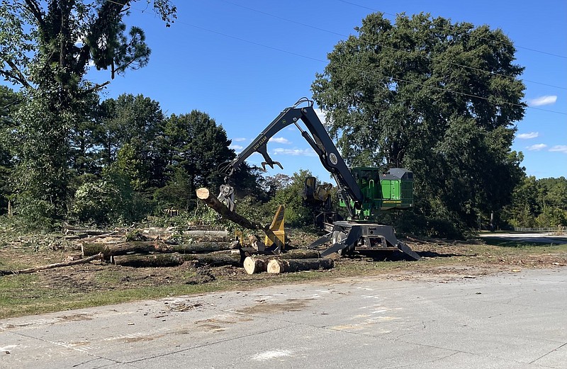 Photo by Dave Flessner / Crews remove trees adjacent to the parking at the former Dupont nylon plant in Hixson, which the Chattanooga-based development firm Rise Partners purchased last week.