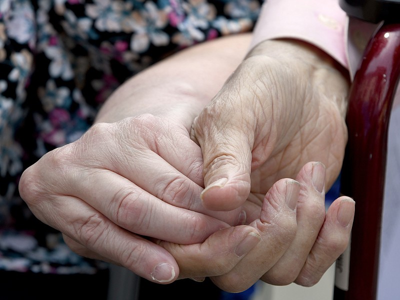 Staff File Photo by Robin Rudd / A couple holds hands during a prayer during the National Day of Prayer observance on the lawn of the Hamilton County Courthouse on May 5, 2022.