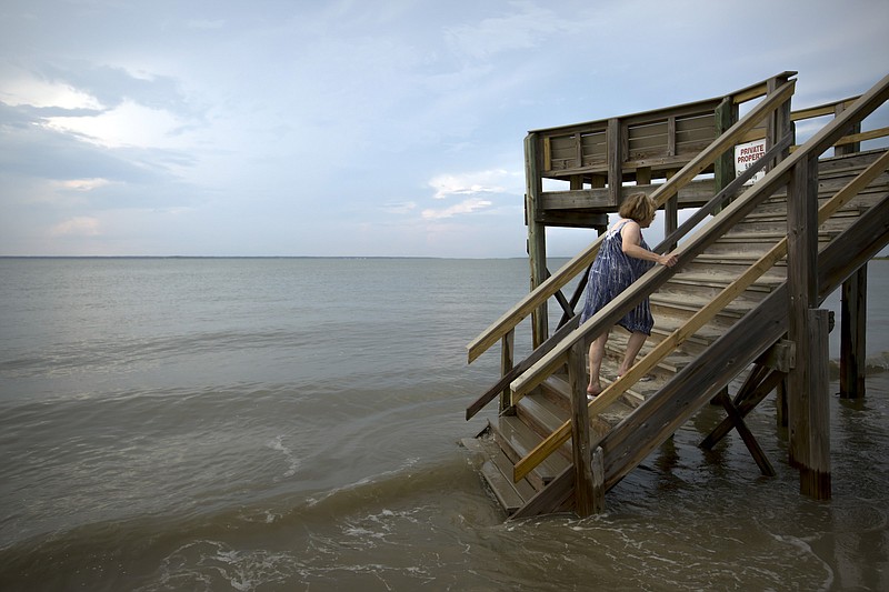 File photo by Stephen B. Morton / The New York Times / Tidal flooding in Tybee Island, Ga., is shown in this June 3, 2016, photo. A new study found that almost 650,000 parcels of privately owned land, across more than 4 million acres, will be below projected tidal boundaries by 2050.