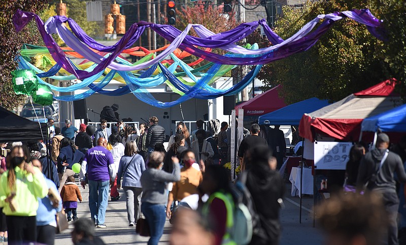 Staff Photo by Matt Hamilton / Residents and visitors enjoy the block party at the intersection of Glass Street and North Chamberlain Ave. on Saturday, Nov. 6, 2021. The block party was held to celebrate the Glass Street neighborhood with food, music, dancing and more.