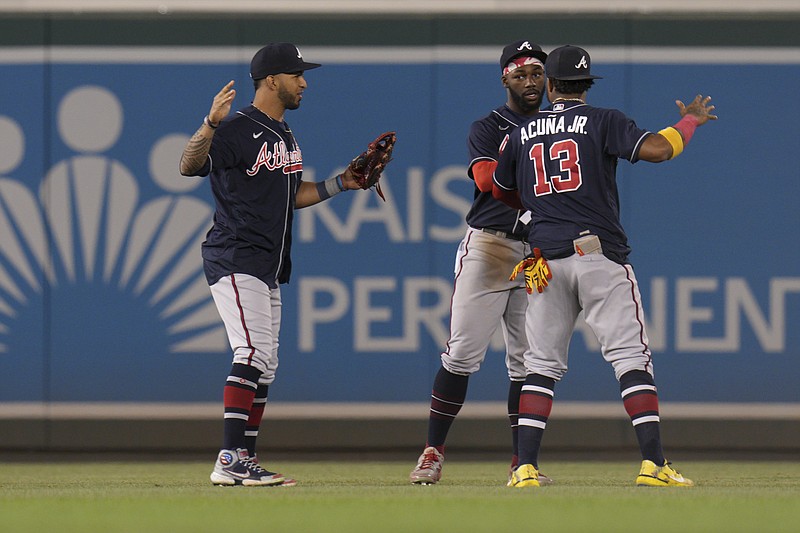 AP photo by Jess Rapfogel / From left, Atlanta Braves outfielders Eddie Rosario, Michael Harris II and Ronald Acuña Jr. celebrate after Tuesday's win against the host Washington Nationals. The Braves pulled even with the first-place New York Mets in the NL East standings that night, but Atlanta is a game behind now with the division's top two teams set to meet in a three-game weekend series at Truist Park.