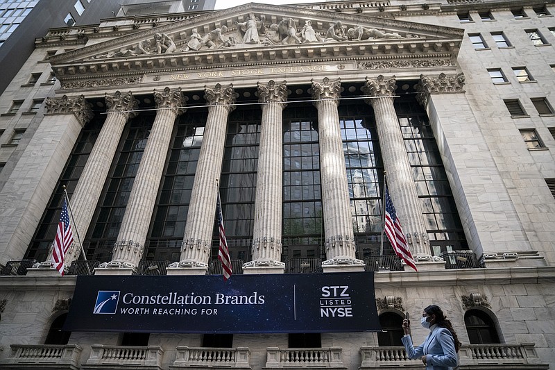 FILE - Pedestrians pass the New York Stock Exchange, Thursday, May 5, 2022, in the Manhattan borough of New York.  Stocks are opening lower on Wall Street, Friday, Sept. 30, on pace to close out another losing month.  (AP Photo/John Minchillo, File)