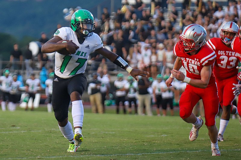 Staff file photo by Olivia Ross / East Hamilton quarterback Juan Bullard, left, rushed for 229 yards and three touchdowns Friday night as the Hurricanes earned a Region 3-4A win at Central.