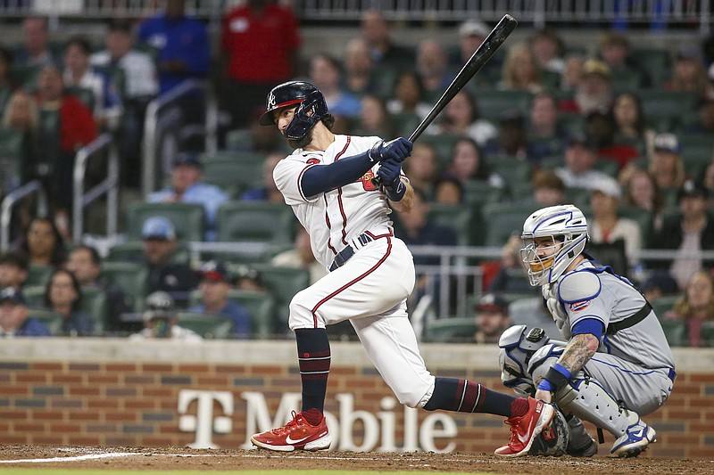 AP photo by Brett Davis / Dansby Swanson follows through on a single for the Atlanta Braves during the third inning of Saturday's home win against the New York Mets in an NL East rivalry matchup.
