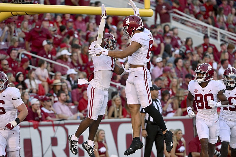 AP photo by Michael Woods / Alabama running back Jahmyr Gibbs, left, celebrates with tight end Cameron Latu after scoring a touchdown during the second half of Saturday's win at Arkansas.