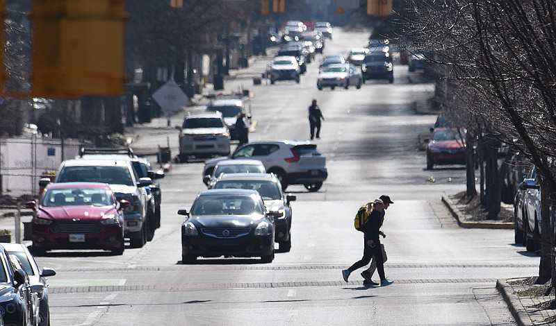 Staff File Photo by Matt Hamilton /  Pedestrians and vehicles compete for space along Broad Street in February 2022.