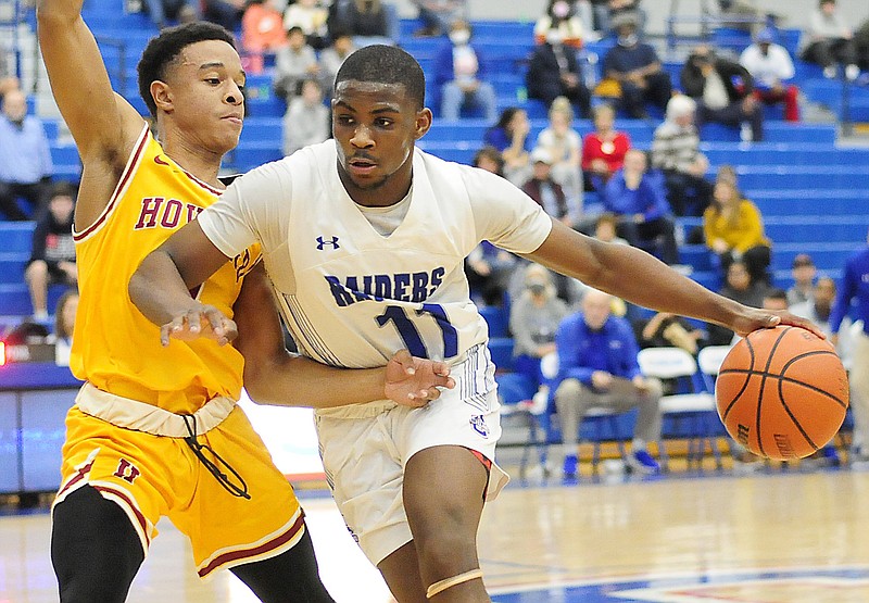 Staff photo by Robin Rudd / Cleveland's Jasen Brooks dribbles as Howard's Jaden Jenkins defends during a game in January. Brooks has committed to UC San Diego.