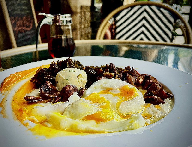 Photo by Anne Braly / Grits topped with fried eggs and a side of mushrooms and greens makes for a filling brunch.