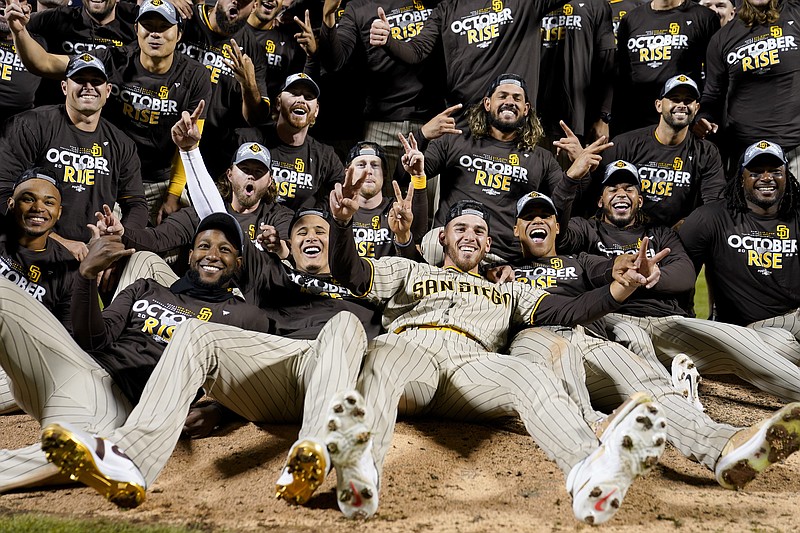 AP photo by John Minchillo / The San Diego Padres celebrate as they pose for a team photo on the field after defeating the host New York Mets 6-0 on Sunday night to win a wild-card series in the NL playoffs.