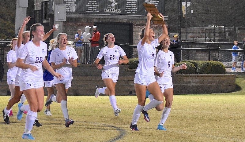 Staff photo by Patrick MacCoon / Boyd Buchanan's Jenna Randolph runs with the TSSAA Division II-A East Region championship plaque to celebrate with fans after a win at Silverdale Baptist Academy on Oct. 13, 2022.