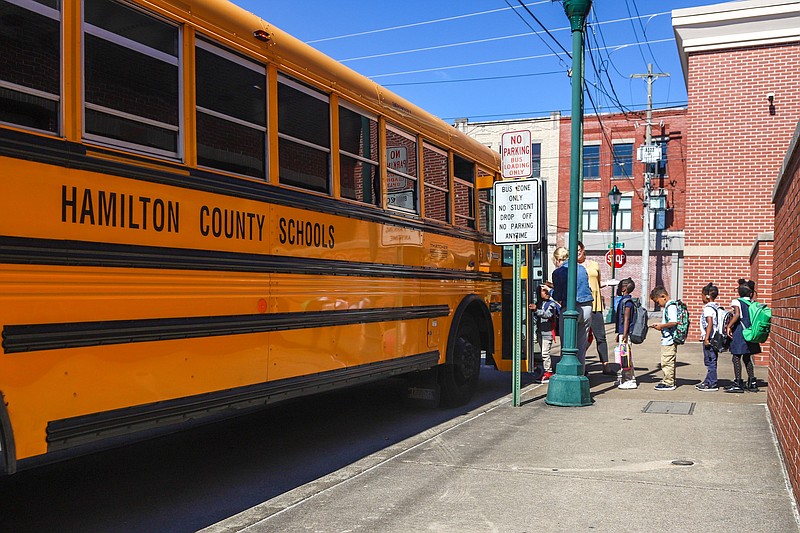 Staff Photo by Olivia Ross  / Following dismissal at Battle Academy, teachers help students load onto buses on Tuesday, October 4, 2022.