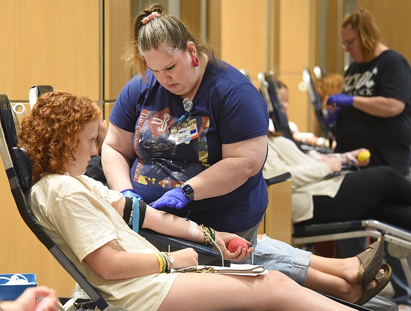 Staff Photo by Matt Hamilton / Phlebotomist Meryl Sutton, right, prepares the arm of Ella Hildebrand for a blood donation on Sept. 28.