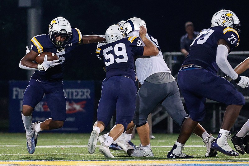 Staff file photo / Chattanooga Christian running back Javoris Havis, left, and his brother Devoris, a defensive end, have helped the Chargers to a 7-1 record this year. The Havis twins have played their senior football season just months after the death of their father, Lavoris.