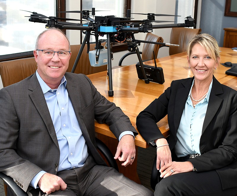 Staff Photo by Robin Rudd / Tim and Shannen Payne pose with a drone used in their business.  Tim and Shannen Payne of Tim Payne Painting talked with the Times Free Press about their innovative methods, at Waterhouse Public Relations, on October 21, 2022.