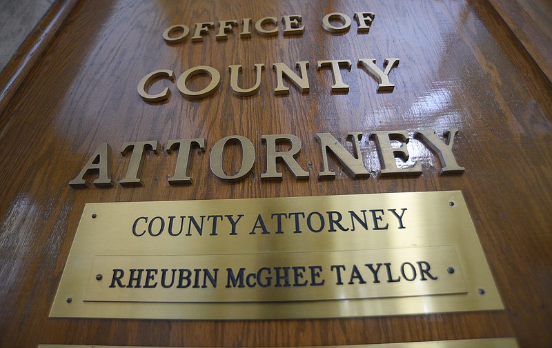 Staff photo by Matt Hamilton / Rheubin Taylor's name remains on the door of the office for the county attorney Tuesday at the Hamilton County Courthouse.