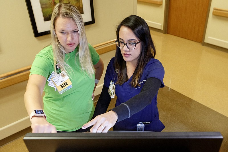 Staff Photo / Nurses Yuliya Belova, left, and Rolla Dayrit use the newly installed Epic electronic health record system in the Clinical Decision Unit at CHI Memorial Hospital on Thursday, Nov. 14, 2019 in Chattanooga, Tenn.