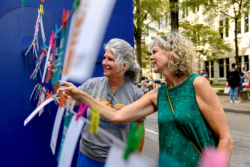 Photo by Mark Gilliland / Patti Dungan and Tam Wood look at photos.