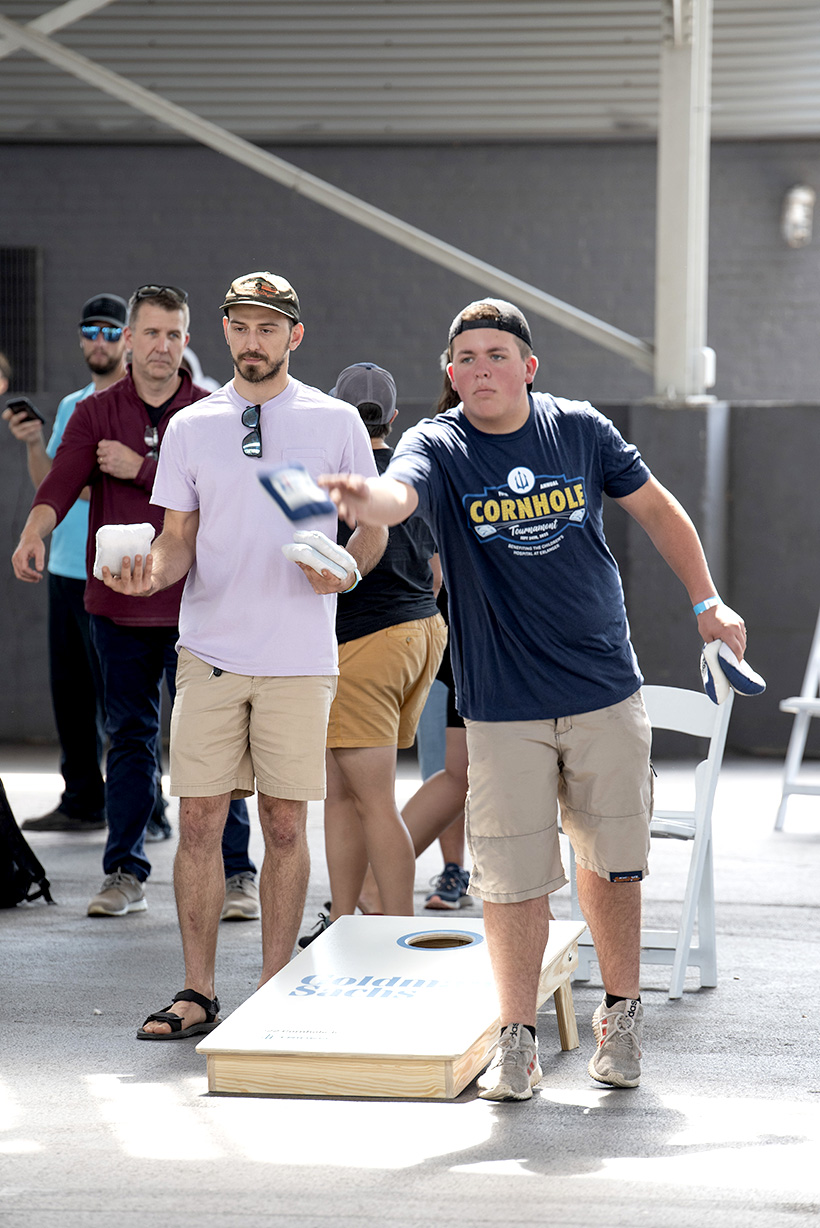 Photo by Michael Hampton / Dylan Casper tosses a bean bag during the cornhole tournament.