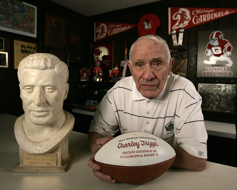 AP photo by John Bazemore / Charley Trippi, a former University of Georgia and NFL star, poses with memorabilia on Jan. 27, 2009, at his home in Athens, Ga.
