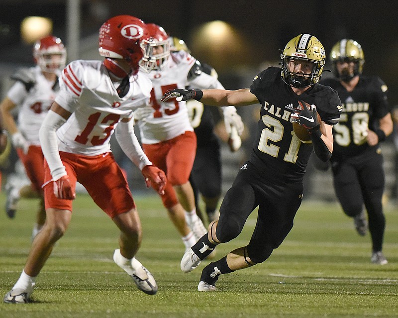 Staff photo by Matt Hamilton / Calhoun's Caden Williams carries the ball past Dalton's RJ Storey (13) during a GHSA Region 7-AAAAA game Friday night in Calhoun, Ga. Williams rushed for 261 yards and three touchdowns on 40 carries.