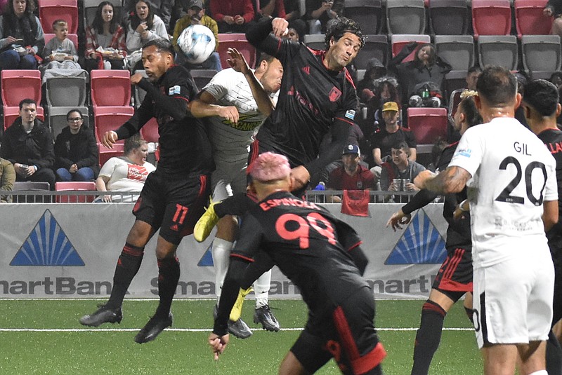 Staff photo by Patrick MacCoon / Chattanooga Red Wolves defenders Josue España (11) and Daniel Navarro (right, leaping) help deny a Union Omaha corner kick in the first half of Saturday's USL League One playoff matchup at CHI Memorial Stadium in East Ridge.