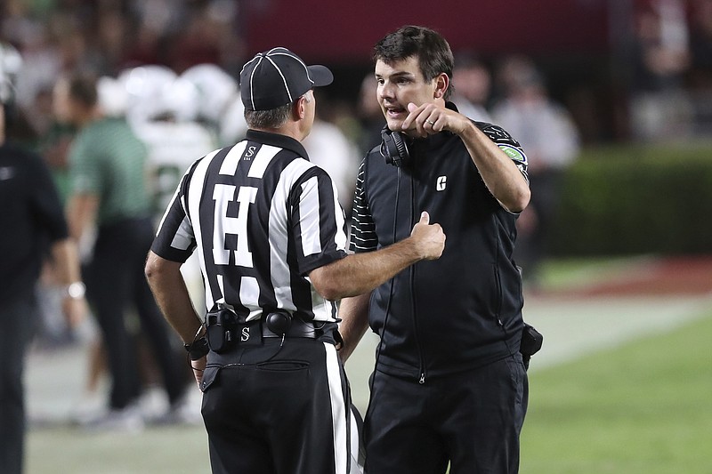 AP photo by Artie Walker Jr. / Charlotte football coach Will Healy talks to an official during the 49ers' game at South Carolina on Sept. 24.
