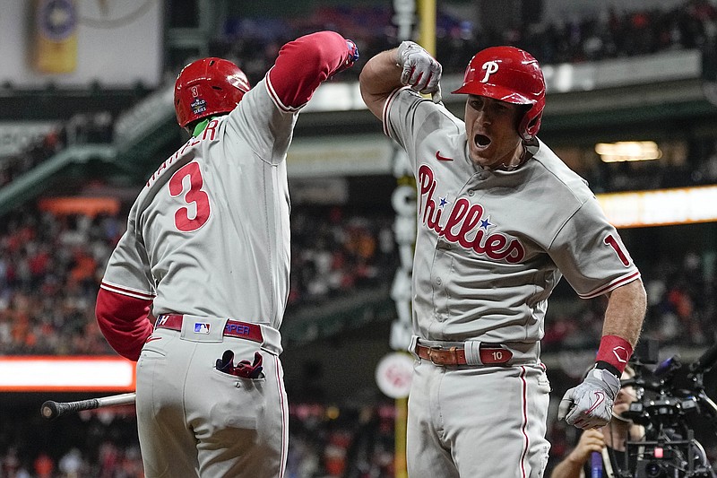 J.T. Realmuto (right) of the Philadelphia Phillies celebrates his go-ahead home run with Bryce Harper during the 10th inning in Game 1 of the World Series against the Houston Astros on Friday in Houston. The Phillies won 6-5. More photos at arkansasonline.com/1029game1/
(AP/David J. Phillip)