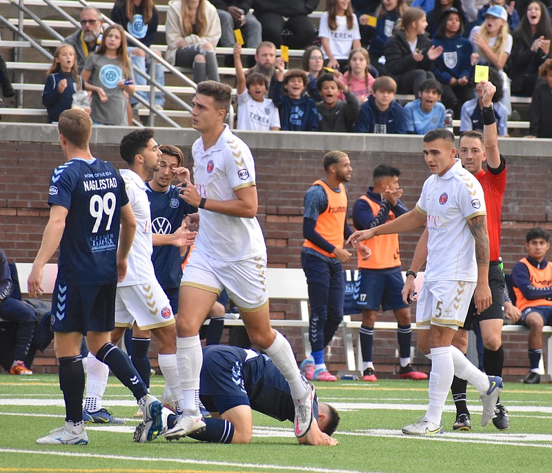 Staff photo by Patrick MacCoon / Chattanooga FC's Alex McGrath, bottom, picks up a yellow card in Sunday's NISA semifinal against the Michigan Stars at Finley Stadium.
