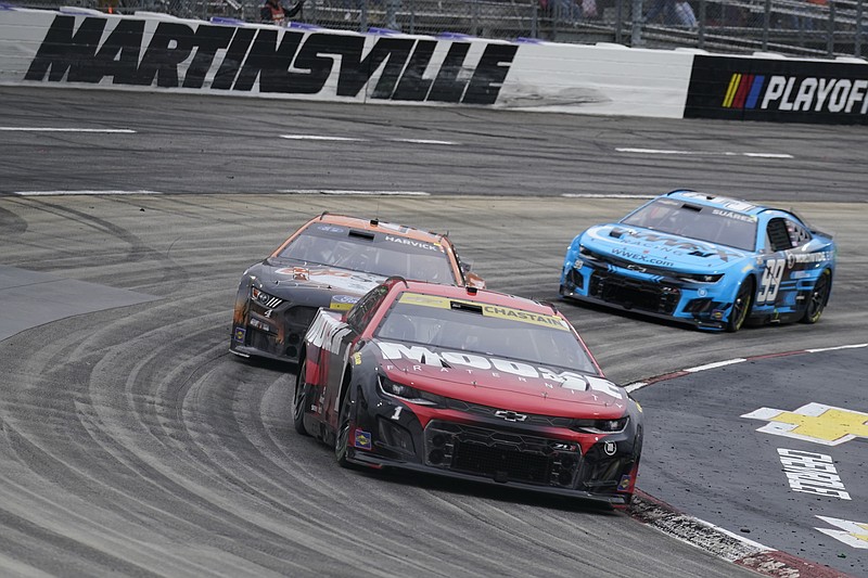 AP photo by Chuck Burton / Ross Chastain races ahead of Kevin Harvick and Daniel Suarez out of the fourth turn at Martinsville Speedway during Sunday's NASCAR Cup Series playoff race in Virginia.