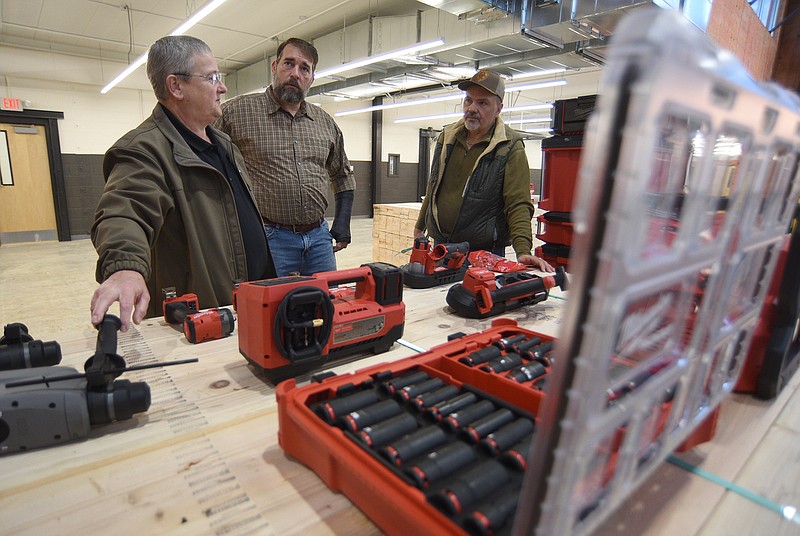 Staff Photo By Matt Hamilton / David Burgess, left, an industrial maintenance instructor at Chattanooga State Community College, shows new tools to instructor Travis Olinger, middle, and adjunct instructor Tim Kerley, right, at the Construction Career Center before its grand opening celebration last week.