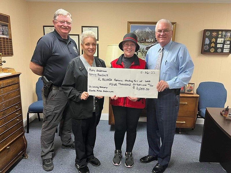 Walker County Sheriff's Office / From let are Deputy Bruce Coker, Nancy Anderson Murdock, Mary “Claus” Anderson and Walker County Sheriff Steve Wilson. Mary "Claus" Anderson donated $4,000 to the Al Millard Memorial Stocking Full of Love charity.