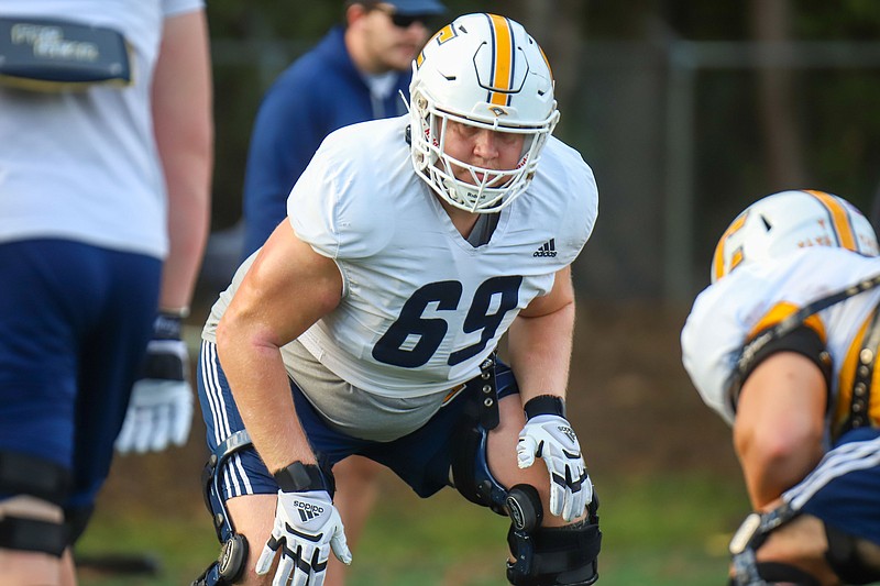 Staff photo by Olivia Ross / UTC offensive lineman Lucas Lavin (69) gets set during practice Wednesday at Scrappy Moore Field. Lavin, a 26-year-old from Sweden, joined the Mocs for his final season of college football after stops in California and Colorado.