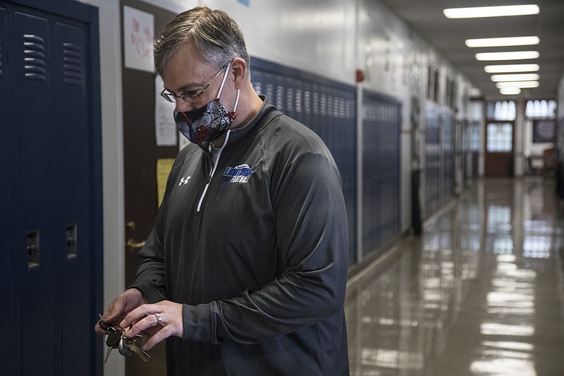 Staff photo by Troy Stolt / Chattanooga School for Arts and Sciences math teacher Bill Bowser locks the door of his classroom on May 13, 2020.