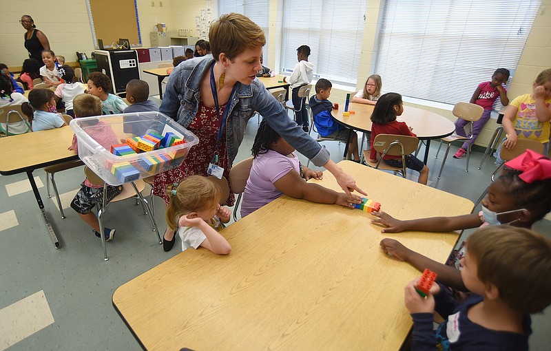 Staff photo by Matt Hamilton / Teacher Elisabeth Baird hands out Lego bricks at Battle Academy for the Summer Reach program on Tuesday, June 7, 2022.